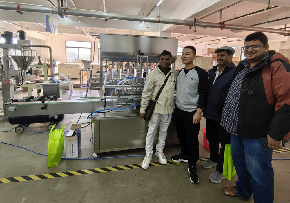 Customer viewing at the factory. They are very satisfied with the machine. They finally ordered a fully automatic eight-head paste filling machine