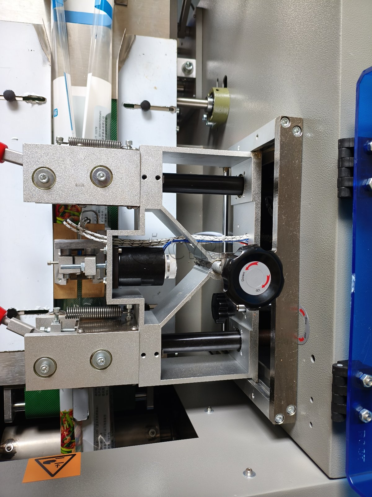 Bottom-film-feed pillow packaging machine with coding unit