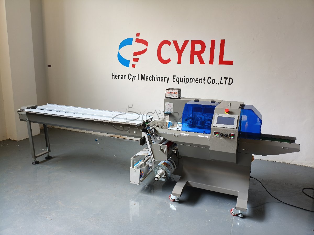 Bottom-film-feed pillow packaging machine with coding unit
