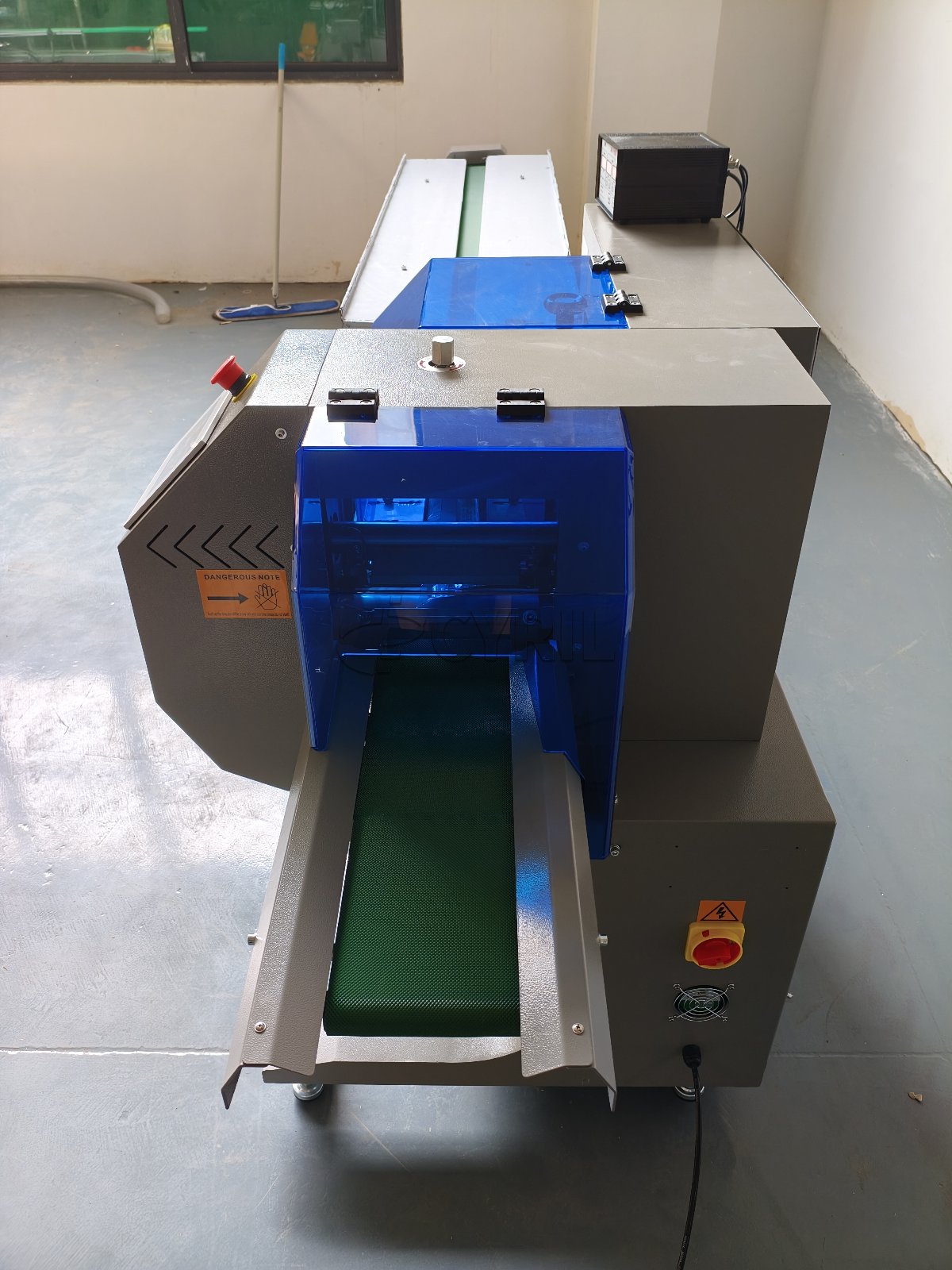 Bottom-film-feed pillow packaging machine with coding unit